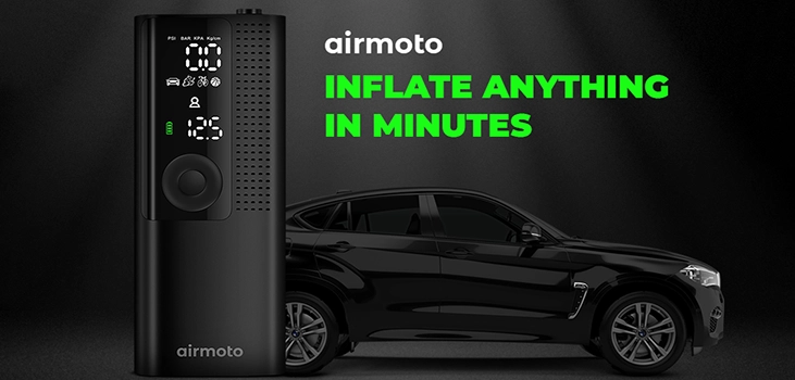 close up of airmoto infront of a black car showing how fast it inflate a tire