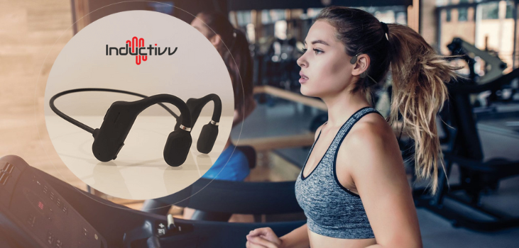 bone-conduction-headphones-inductivv lady in gym running on treadmill